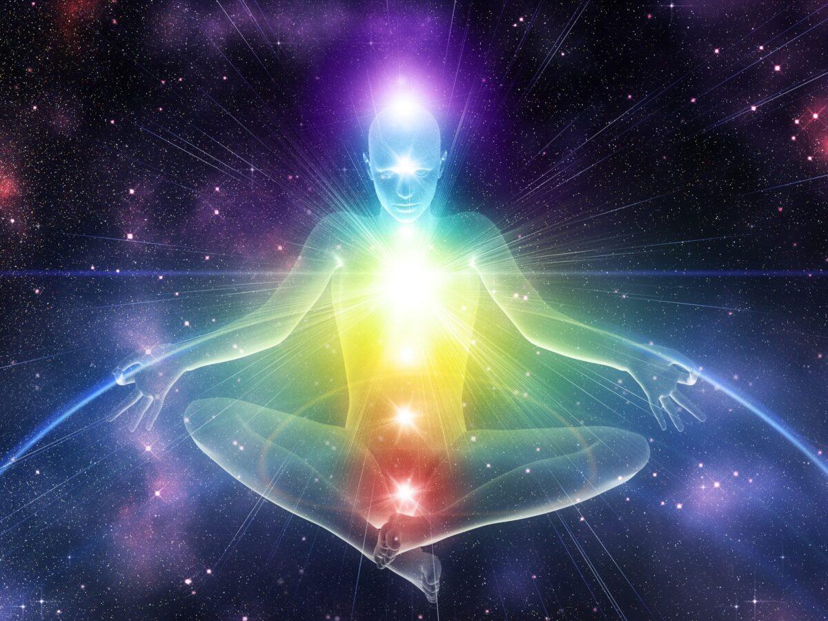 Digitally rendered 3d illustration of human maneken in yoga position with glowing chakras background.