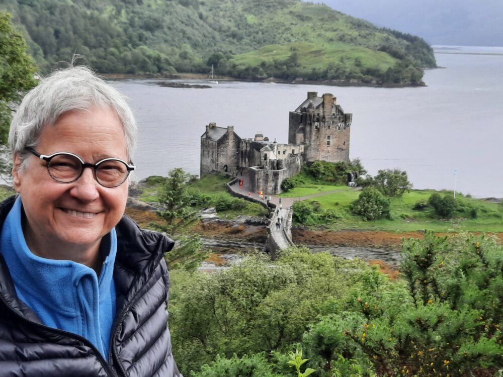 woman smiling with old castle in background